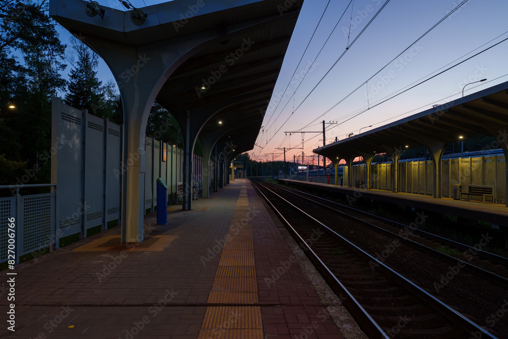 A beautiful railway station in the rays of a colorful sunset