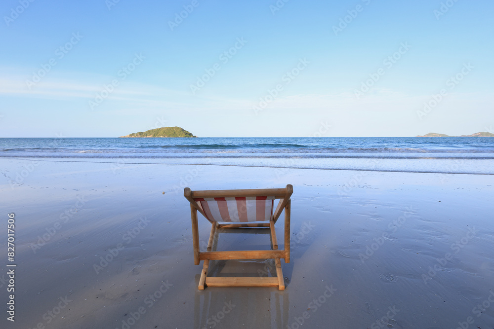 Wooden lounge chairs on a beautiful tropical beach