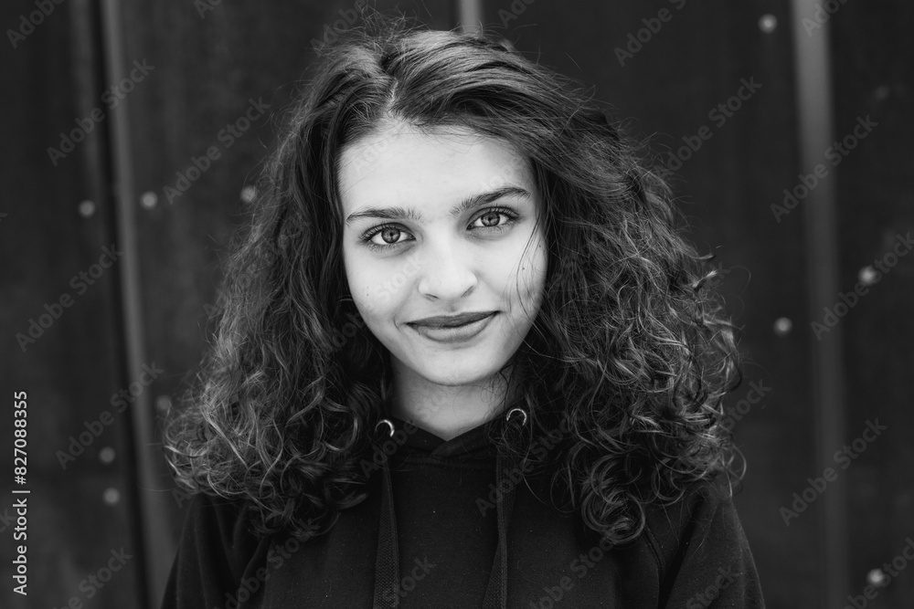 photo with a portrait of a schoolgirl or teenager with curly hair and beautiful eyes in black and white. photo with a portrait of a schoolgirl or teenager with curly hair and beautiful eyes in black and white.