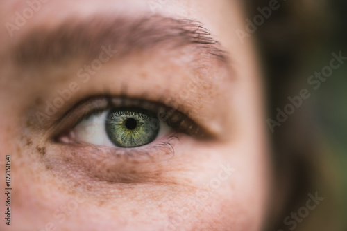 Close-up of a green eye with freckles and detailed features