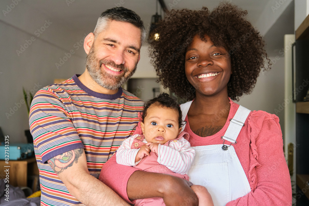 Portrait of a multiracial family with a baby at home. Portrait of a multiracial family with a baby at home.