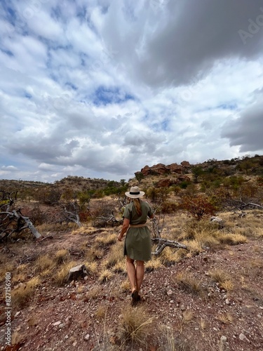Woman in a safari dress hiking in the mountains