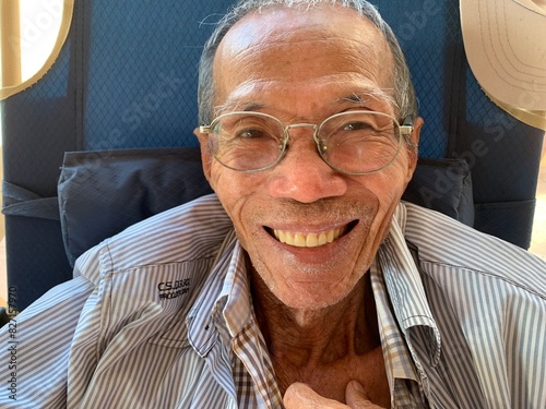 Old man smiles, showing dentures