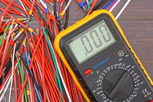 A digital multimeter for measuring the parameters of electrical circuits in an electrical diagram. Close-up. photo