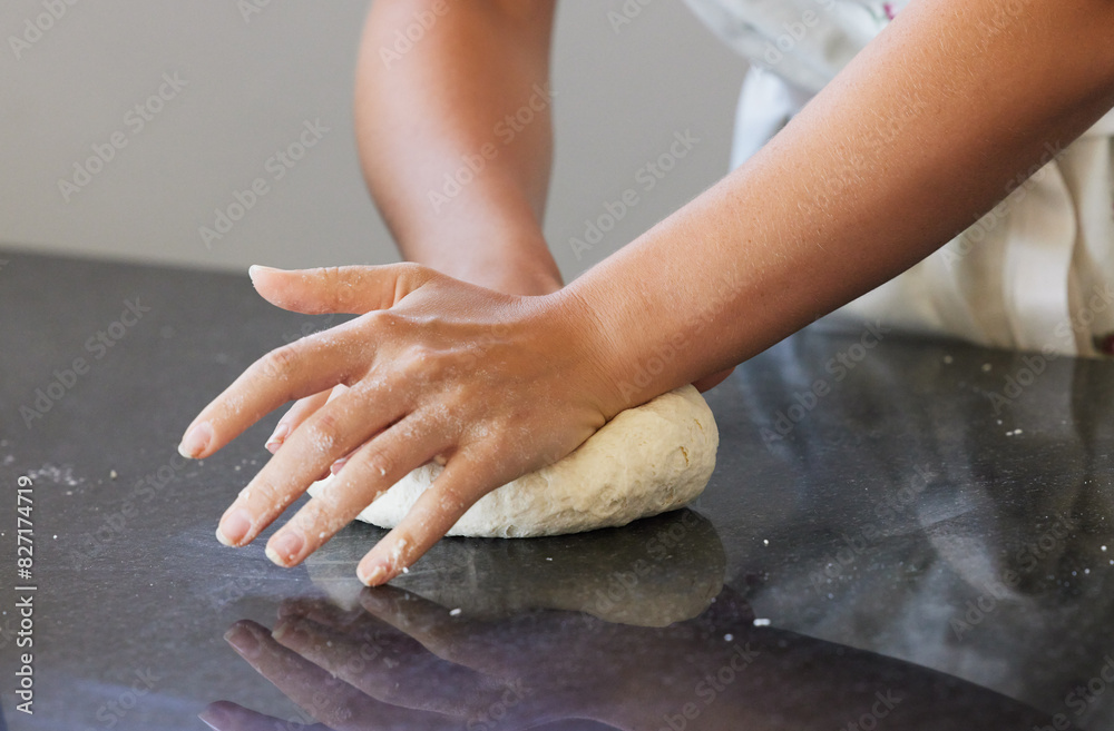 Person, hands and kneading dough in kitchen or baking bread for morning breakfast, cooking or dessert. Chef, counter and wheat production for pizza meal or learning recipe, preparing or restaurant Person, hands and kneading dough in kitchen or baking bread for morning breakfast, cooking or dessert. Chef, counter and wheat production for pizza meal or learning recipe, preparing or restaurant