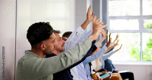 Business People Vote And Raise Questions At Team Event photo