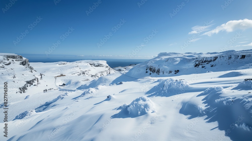 A remote mountain pass, blanketed in pristine snow, offers endless views and captivating scenery under clear skies. A remote mountain pass, blanketed in pristine snow, offers endless views and captivating scenery under clear skies.