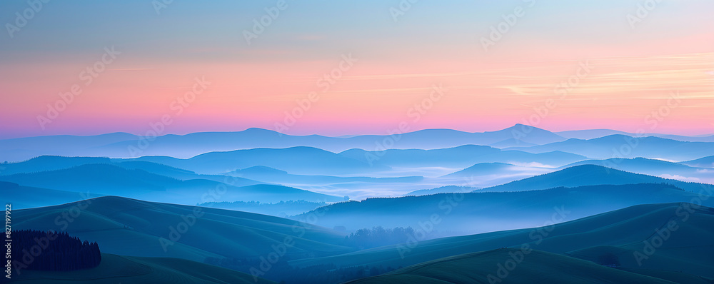 Obraz premium Serene mountain landscape at sunrise with layers of mist and colorful sky creating a peaceful and tranquil scene in nature.