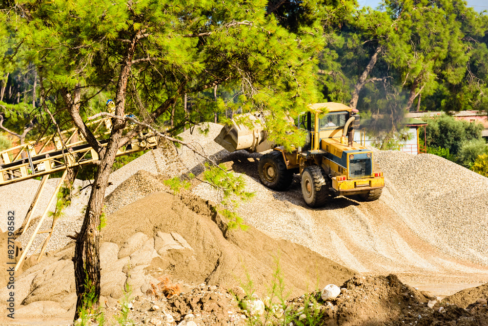 Heavy excavator working at the limestone quarry. Mining industry Heavy excavator working at the limestone quarry. Mining industry