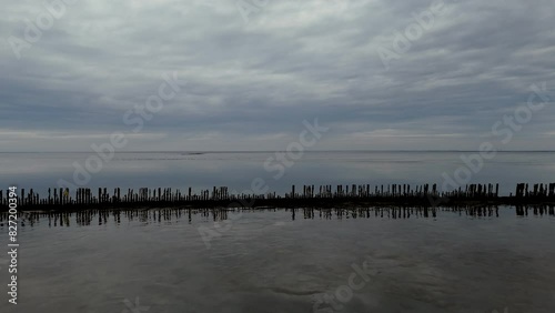 Aerial View: Wadden Sea near Wierum, Friesland, Netherlands with Wooden Posts and Stunning Cloud Reflections photo