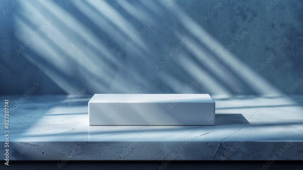 A white box sits on a concrete countertop, with a shadow cast on it A white box sits on a concrete countertop, with a shadow cast on it