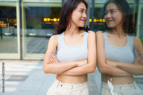 pretty young asian woman looking at her reflection in the mirror self appreciation