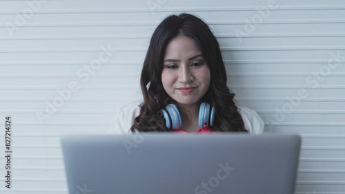 young asian woman working on laptop
