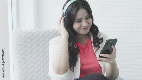 young asian woman listening to music with smart phone 