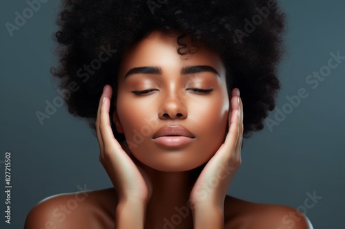 Portrait, beauty and facial with a black woman in studio to promote natural skincare or treatment. Face, skin and wellness with an attractive young female touching her cheeks for dermatology