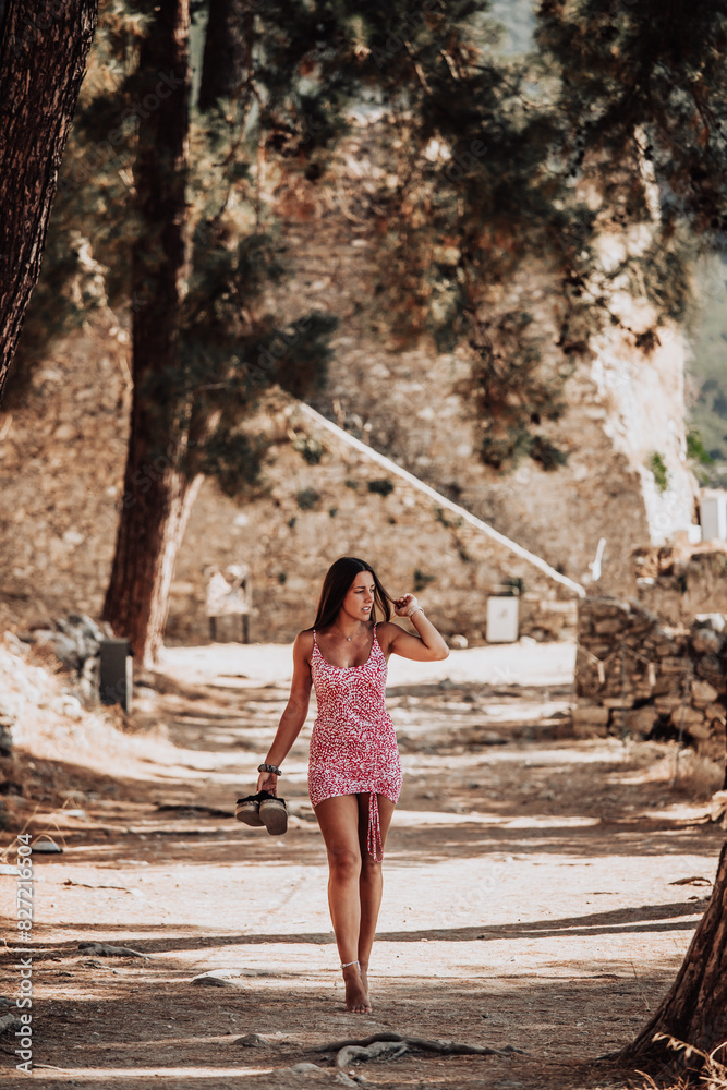 Woman in short dress walks barefoot on path. Woman in short dress walks barefoot on path.