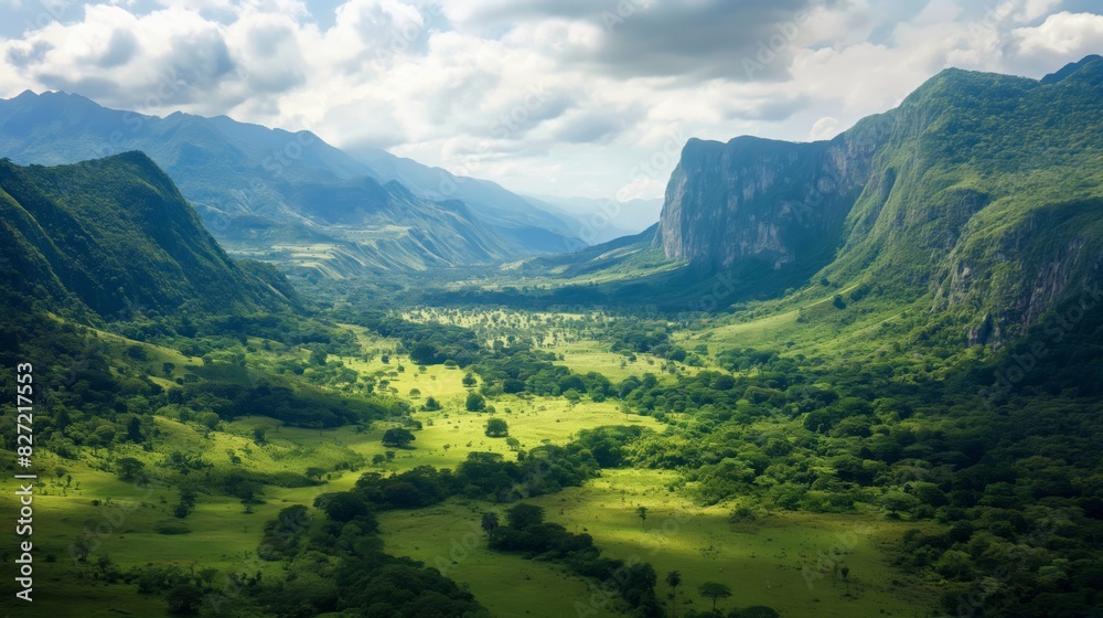 Obraz premium Expansive and majestic mountain valley landscape with lush green fields and dramatic sky, an outdoor natural wonder for hiking and tourism adventure