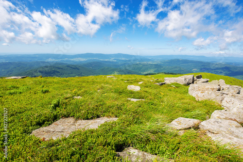 alpine landscape of ukrainian carpathians in summer. stones on the green meadow of mnt. smooth. beautiful scenery of mnt. smooth beneath a blue sky with clouds on a sunny day
