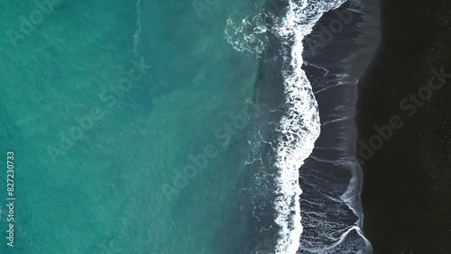 Horizontal Drone Shot of Black Sand Beach in Indonesia. Aerial View Top Down waves crushing.  photo