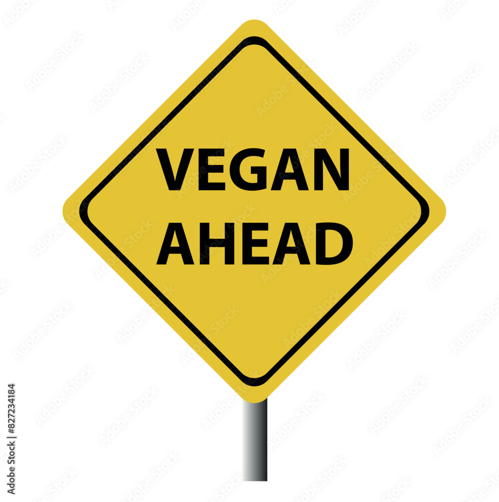 A yellow and black diamond shaped road sing with the words vegan ahead making a great concept. A yellow and black diamond shaped road sing with the words vegan ahead making a great concept.