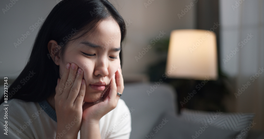 Portrait of Unwell young woman suffering from severe stomach ache while lying on sofa in the living room, feeling extremely sick, female experiencing period cramps. Portrait of Unwell young woman suffering from severe stomach ache while lying on sofa in the living room, feeling extremely sick, female experiencing period cramps.