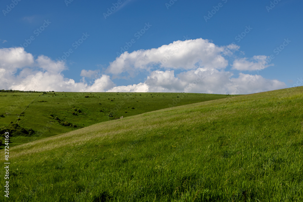 A rural Sussex landscape at Mount Caburn, with a blue sky overhead