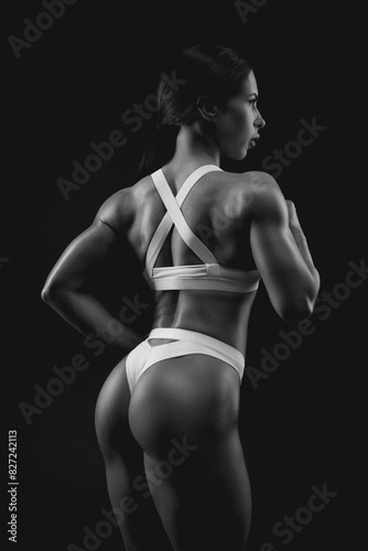 Black and white image of a sports woman in the studio. Beautiful body.