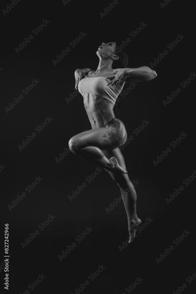 Black and white image of a sports woman in the studio. Beautiful body. Black and white image of a sports woman in the studio. Beautiful body.