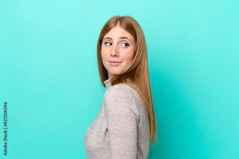 Young redhead woman isolated on blue background . Portrait Young redhead woman isolated on blue background . Portrait