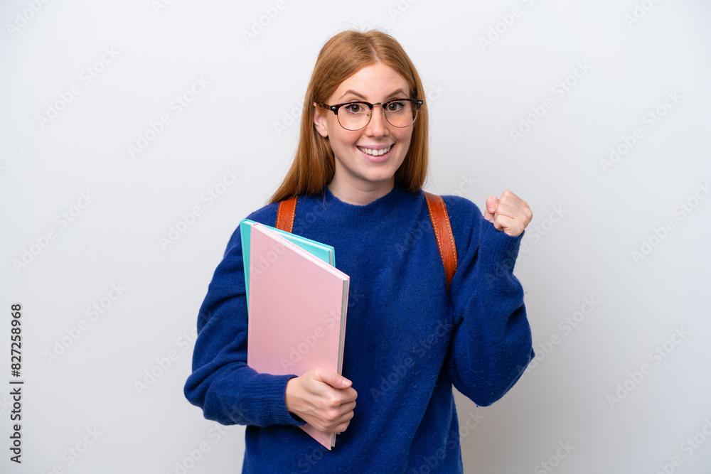 Young student redhead woman isolated on white background celebrating a victory in winner position Young student redhead woman isolated on white background celebrating a victory in winner position