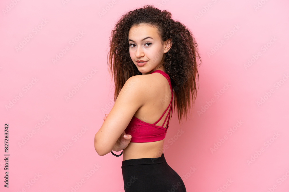 Young Sport Arab woman isolated on pink background