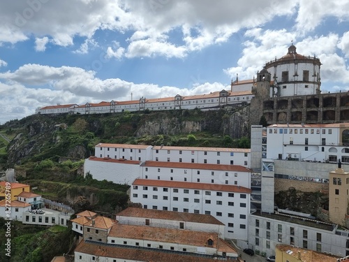 Porto, Portugal, typical architecture in the city center with white houses and red roofs, green nature near the buildings