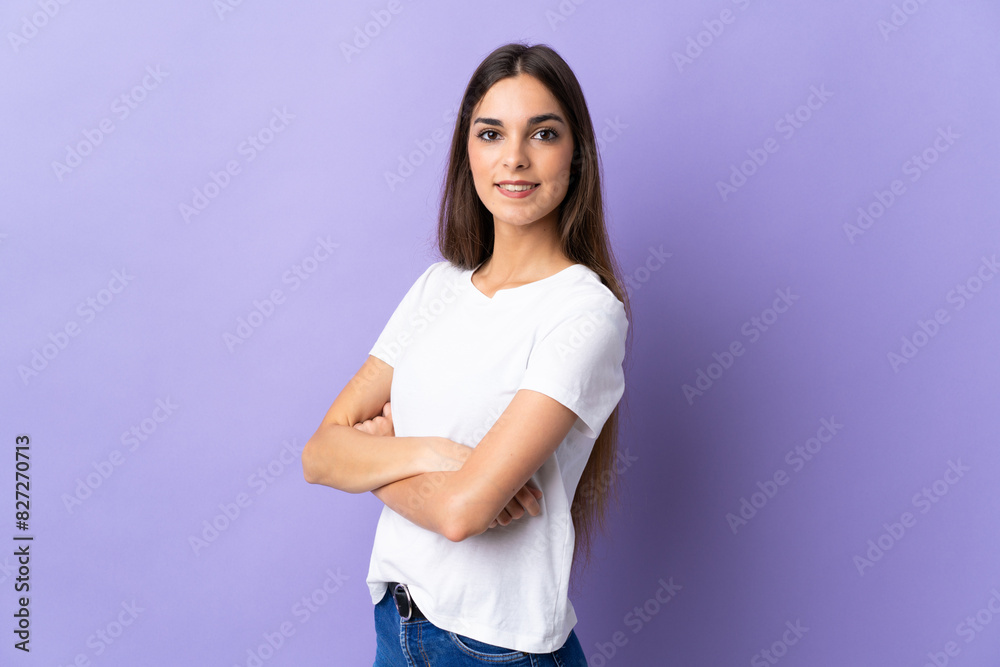 Young caucasian woman isolated on blue background with arms crossed and looking forward Young caucasian woman isolated on blue background with arms crossed and looking forward