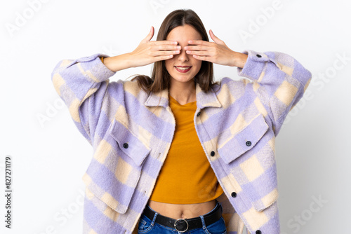 Young caucasian woman isolated on purple background covering eyes by hands