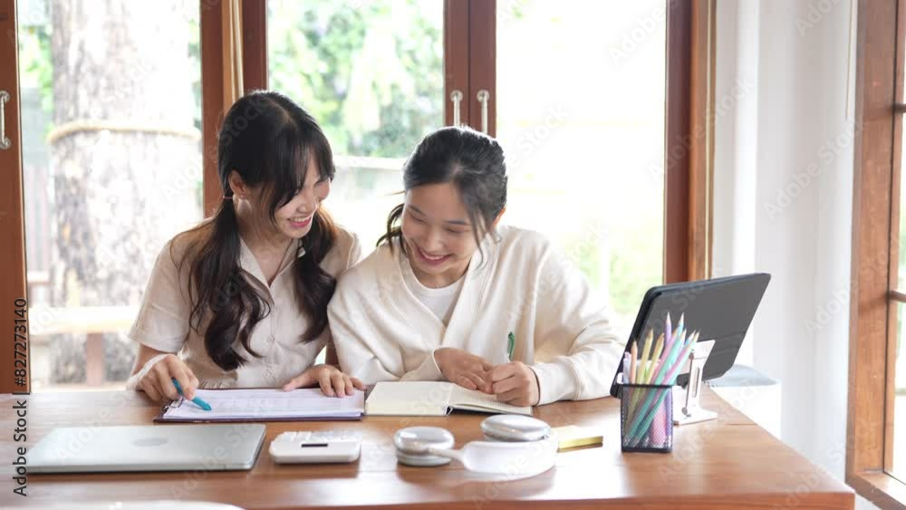 Two asian woman tutoring outside the classroom with friends. Two asian woman tutoring outside the classroom with friends.