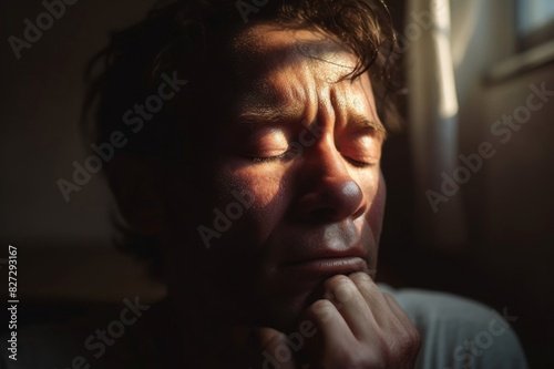 close-up of worried man with eyes closed at home
