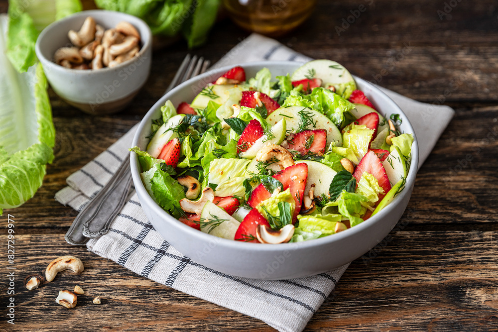 Fresh salad with lettuce leaves, apples, strawberries and cashew nuts Fresh salad with lettuce leaves, apples, strawberries and cashew nuts