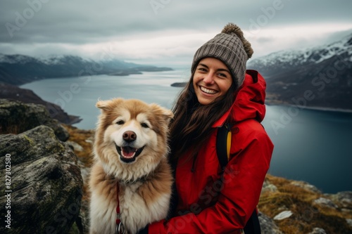 Happy woman with her dog hiking in the mountains © alisaaa