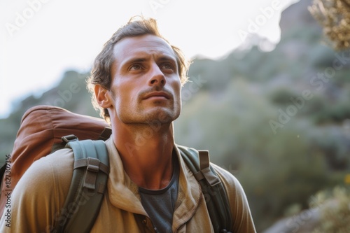mid adult man looking up while hiking during weekend
