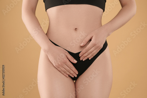 Gynecology. Woman in underwear on yellow background, closeup © New Africa