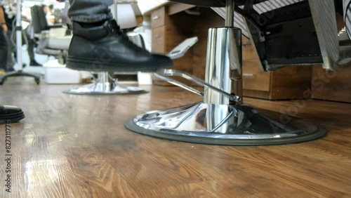 Person in barber chair getting ready for haircut in barber shop