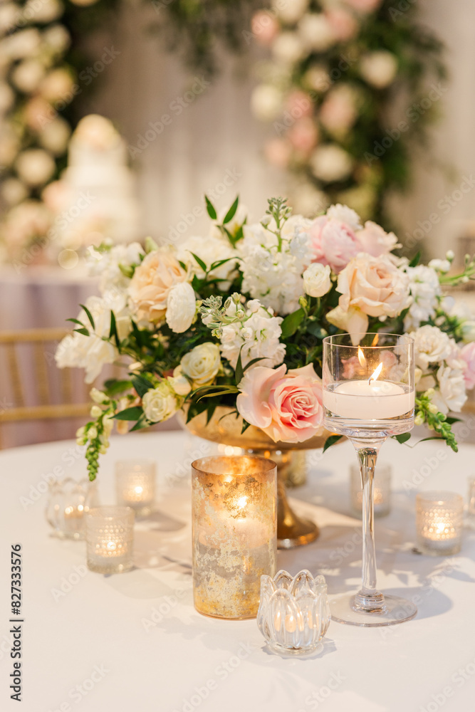 Centerpiece with white and pink flowers and multiple candles Centerpiece with white and pink flowers and multiple candles
