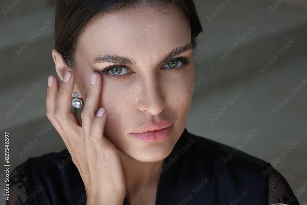 Beautiful brunette woman doing self make-up with a cream. Portrait of young pretty woman in black night gown in her bathroom near mirror. Closeup, big lips. Cream apply closeup Beautiful brunette woman doing self make-up with a cream. Portrait of young pretty woman in black night gown in her bathroom near mirror. Closeup, big lips. Cream apply closeup