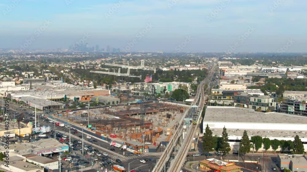 Aerial Panning Forward Shot Of U.S. Flag On Crane In Residential City During Sunny Day - Culver City, California Aerial Panning Forward Shot Of U.S. Flag On Crane In Residential City During Sunny Day - Culver City, California