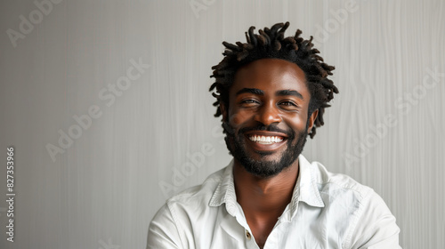 African American actor smiling on stage, plain white background