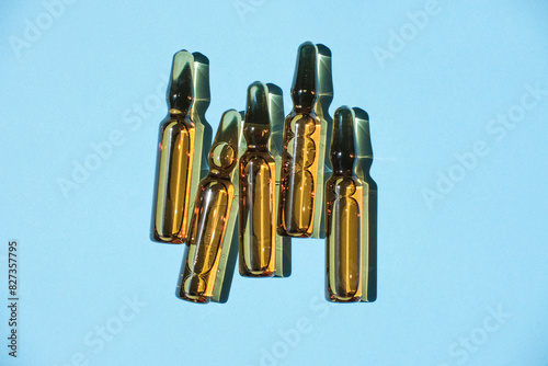 Cosmetic or medical ampoules on a blue background.