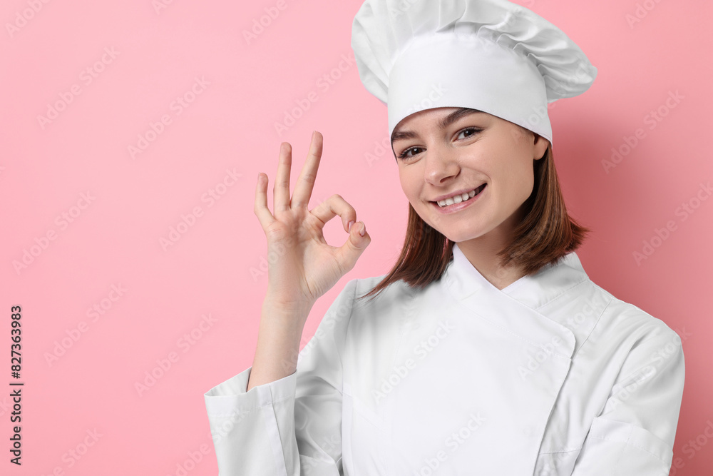 Professional chef showing OK gesture on pink background. Space for text Professional chef showing OK gesture on pink background. Space for text