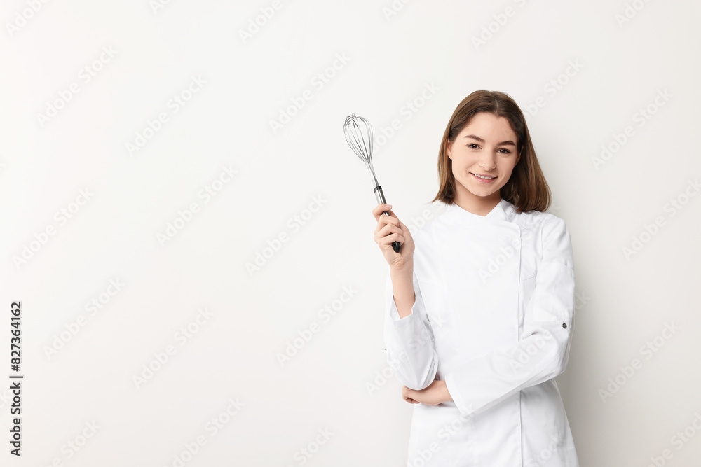 Professional chef with whisk on light background. Space for text Professional chef with whisk on light background. Space for text