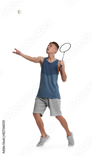 Young man playing badminton with racket and shuttlecock on white background © New Africa