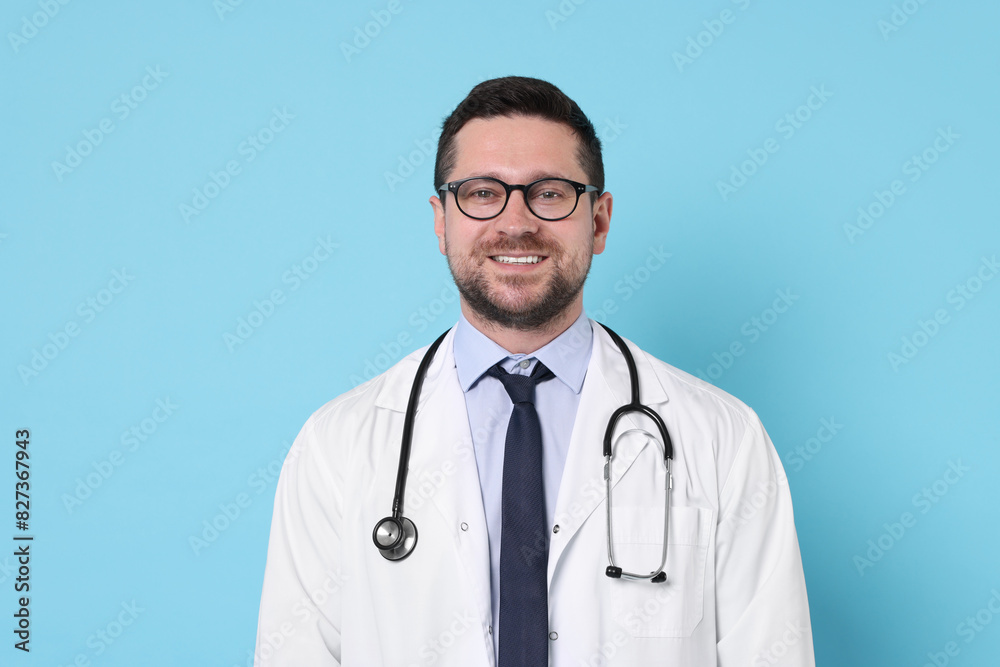 Portrait of smiling doctor on light blue background Portrait of smiling doctor on light blue background